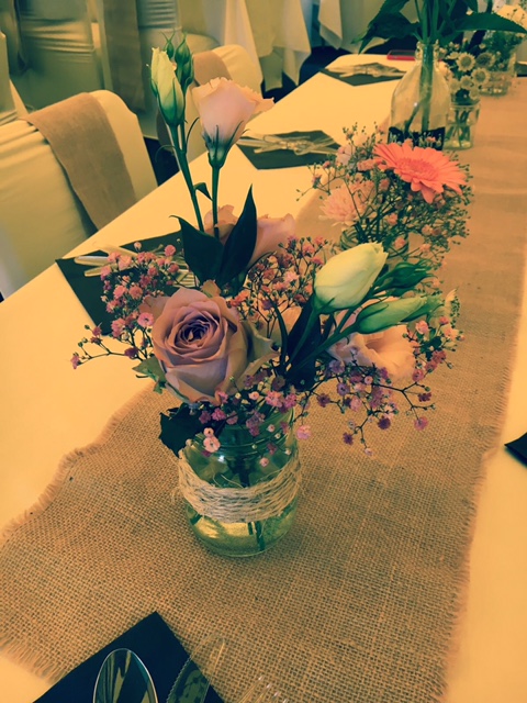 Jam jar filled with summer flowers 